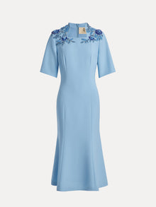 The Social Queen Handcrafted Beaded Floral Dress is a sky-blue, knee-length dress with short sleeves and hand-embroidered 3D floral appliqués on the shoulders.