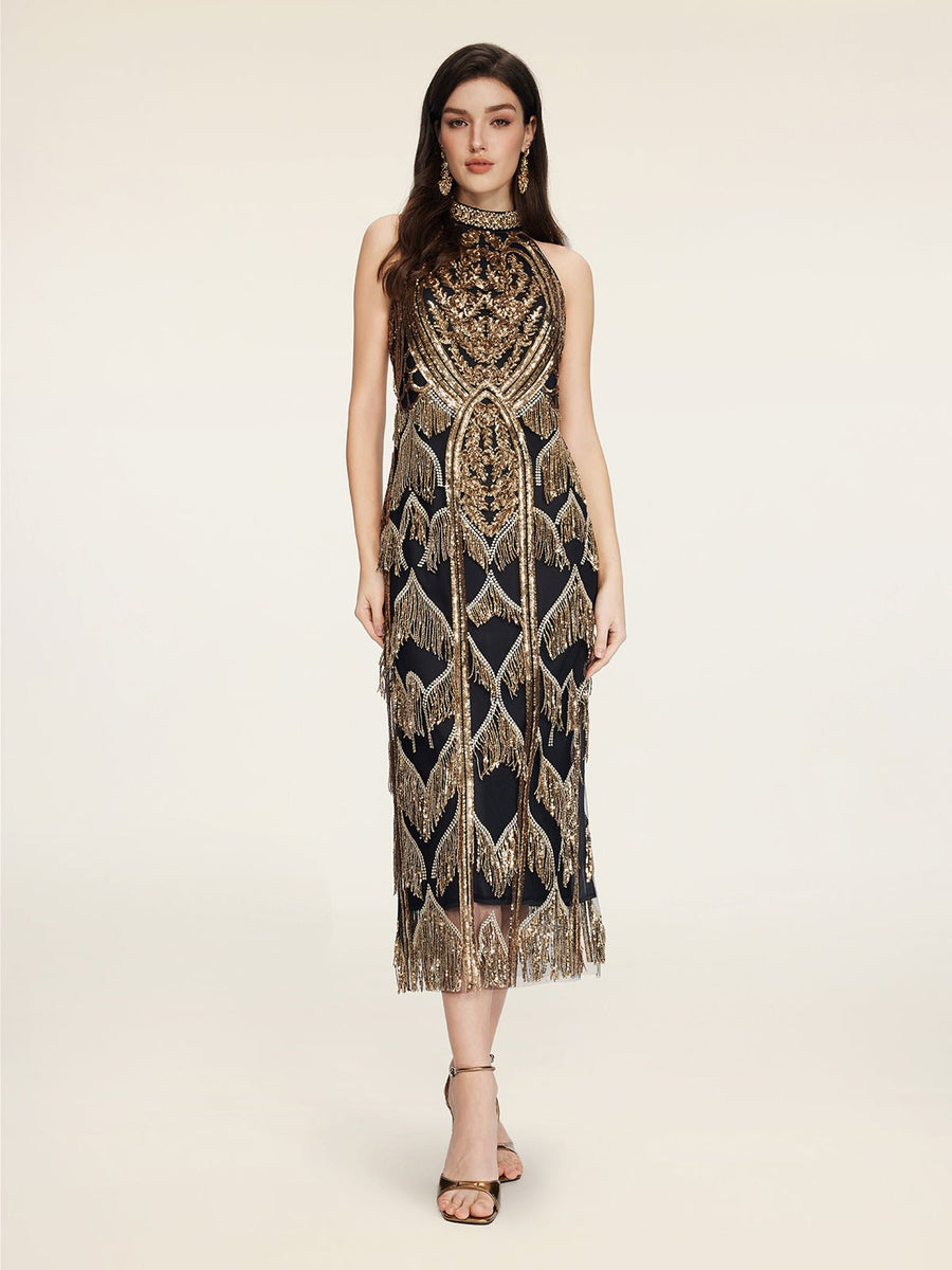 A woman models the Social Queen Handcrafted Fringe Sequin Halter Gown, featuring hand-applied sequins and geometric patterns, against a plain light background.