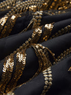 Close-up of black fabric from the Handcrafted Fringe Sequin Halter Gown by Social Queen, featuring hand-applied sequins and beaded embellishments in wavy lines.