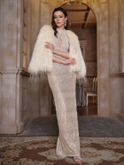 A woman stands in an ornate room wearing a sparkly floor-length gown, large earrings, and the Social Queen Handmade Fringed Trench Coat in Genuine Wool.