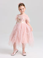 A young girl wears the Social Queen Girls Floral Sequin Tulle Dress with matching pink shoes, posing against a plain light background.