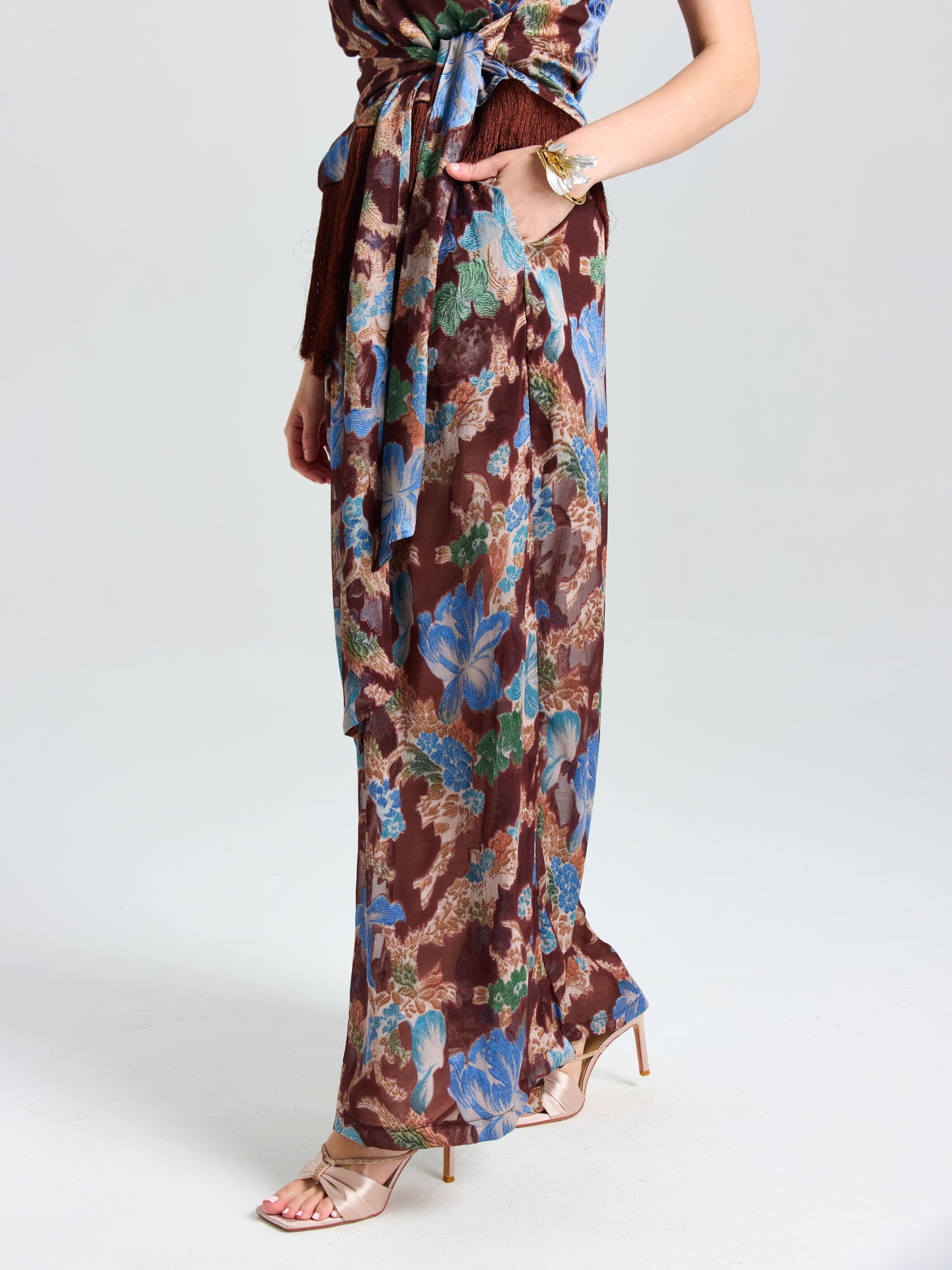 A person wearing Social Queen Floral Print Wide-Leg Pants and beige high-heeled sandals, showcasing effortless vacation style against a plain light background.