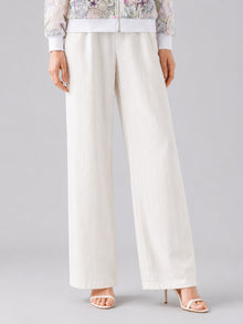 A person wearing Social Queen’s Casual Wide-Leg Pants, featuring a mid-high rise and lyocell-linen blend, paired with open-toe high heels, stands against a plain background, with only the lower half of their body visible.