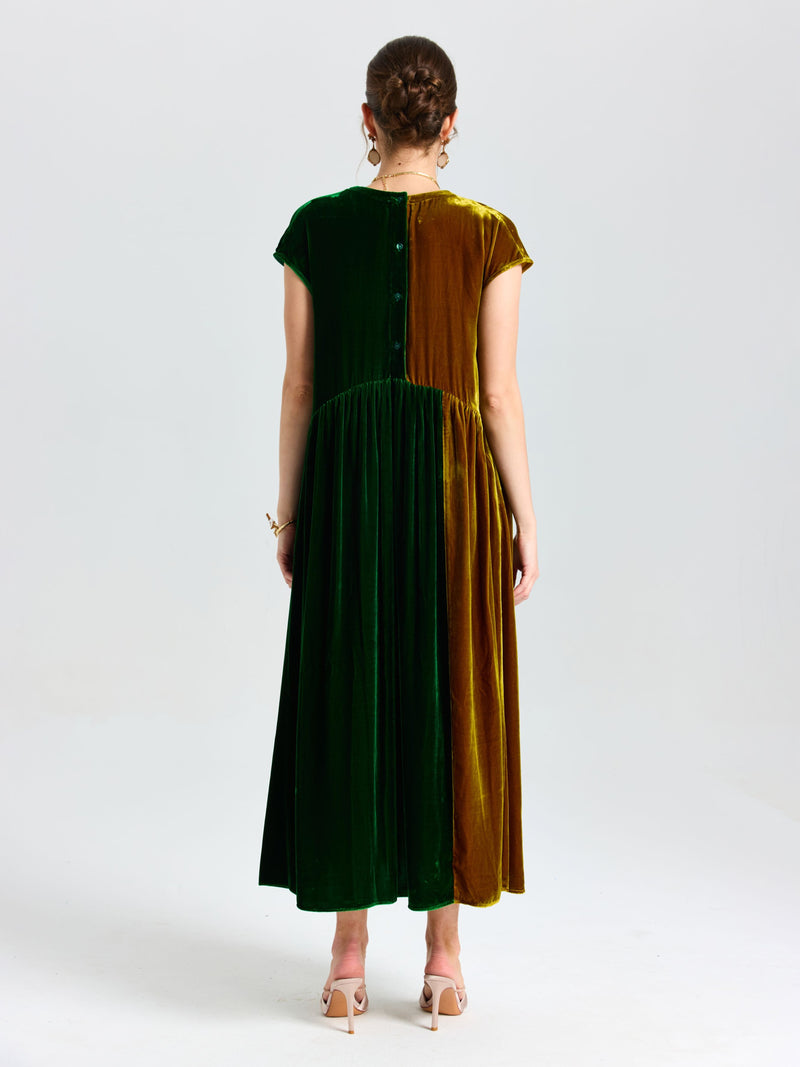 A woman faces away wearing the Social Queen Colorblock Silk Velvet Shift Dress in green and brown with short sleeves, button-back detail, and nude heels.