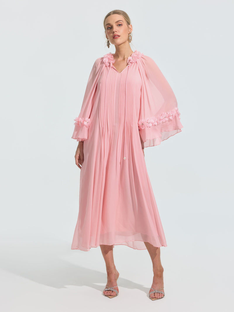 A woman wears the Social Queen 3D Floral Embellished Silk Dress in light pink, featuring long sleeves and 3D floral details on the sleeves and shoulders, paired with open-toe heels against a plain background.