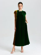 A woman wearing the Social Queen Colorblock Silk Velvet Shift Dress with cap sleeves and a beaded neckline, paired with open-toe heels, stands against a plain white background.