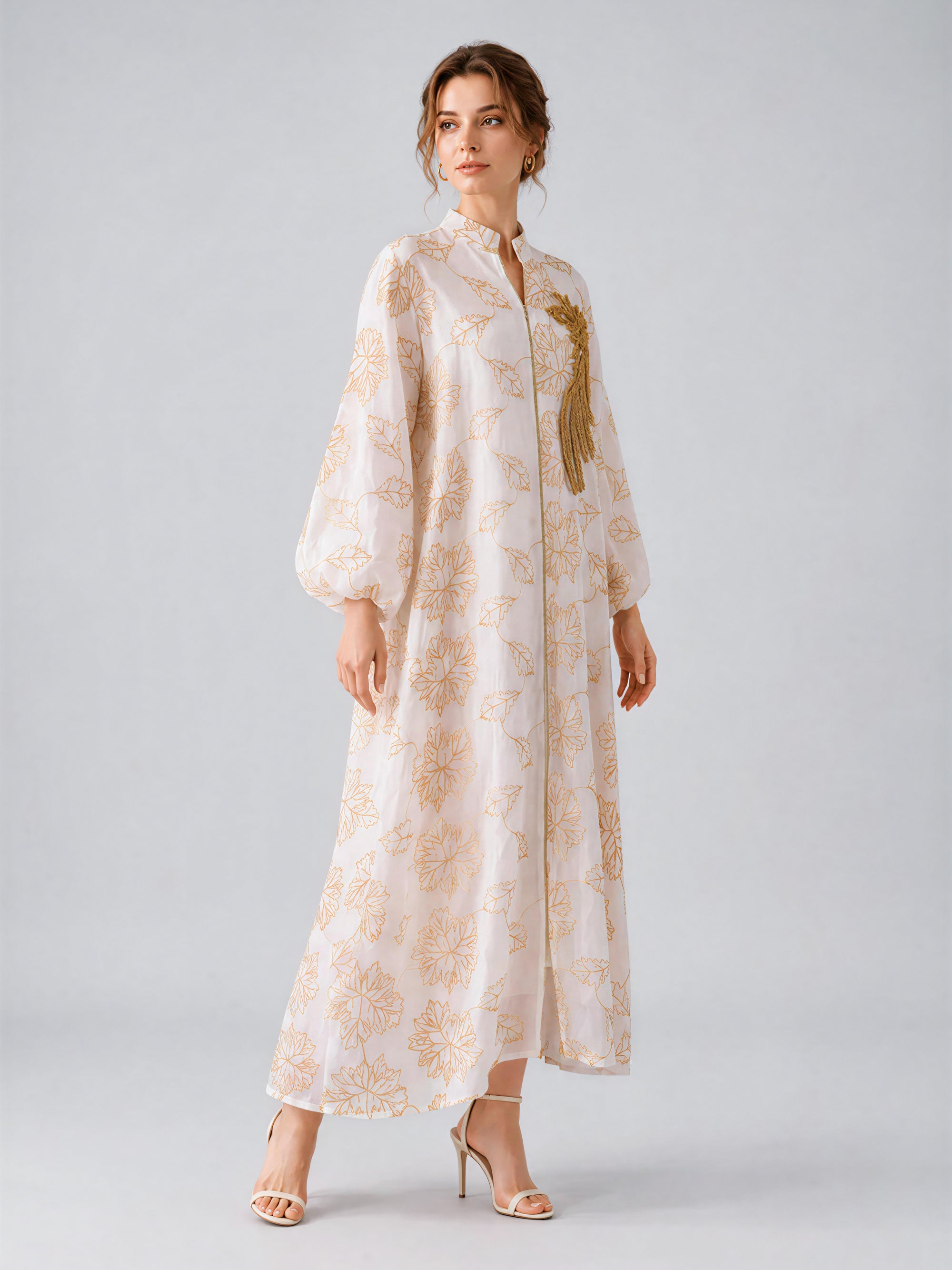 A woman wearing the Social Queen Leaf Embroidered Beaded Dress—with long sleeves and delicate beaded leaf embroidery—paired with heeled sandals, stands against a light gray background.