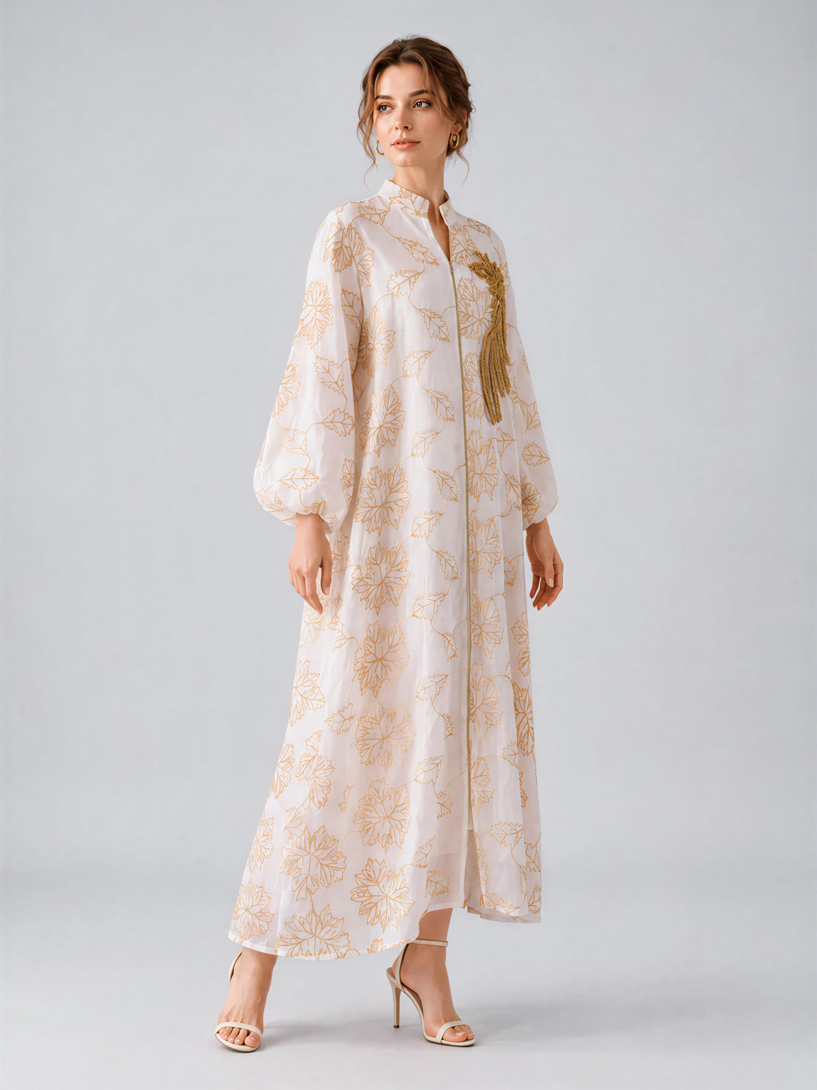 A woman wearing the Social Queen Leaf Embroidered Beaded Dress—with long sleeves and delicate beaded leaf embroidery—paired with heeled sandals, stands against a light gray background.