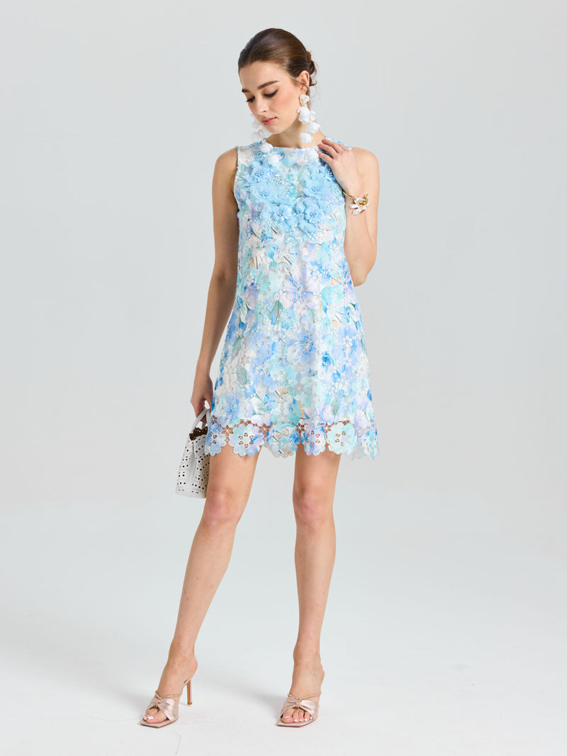 A woman in the Social Queen Embellished Floral Lace Mini Dress stands with a small handbag, looking down against a plain light background.