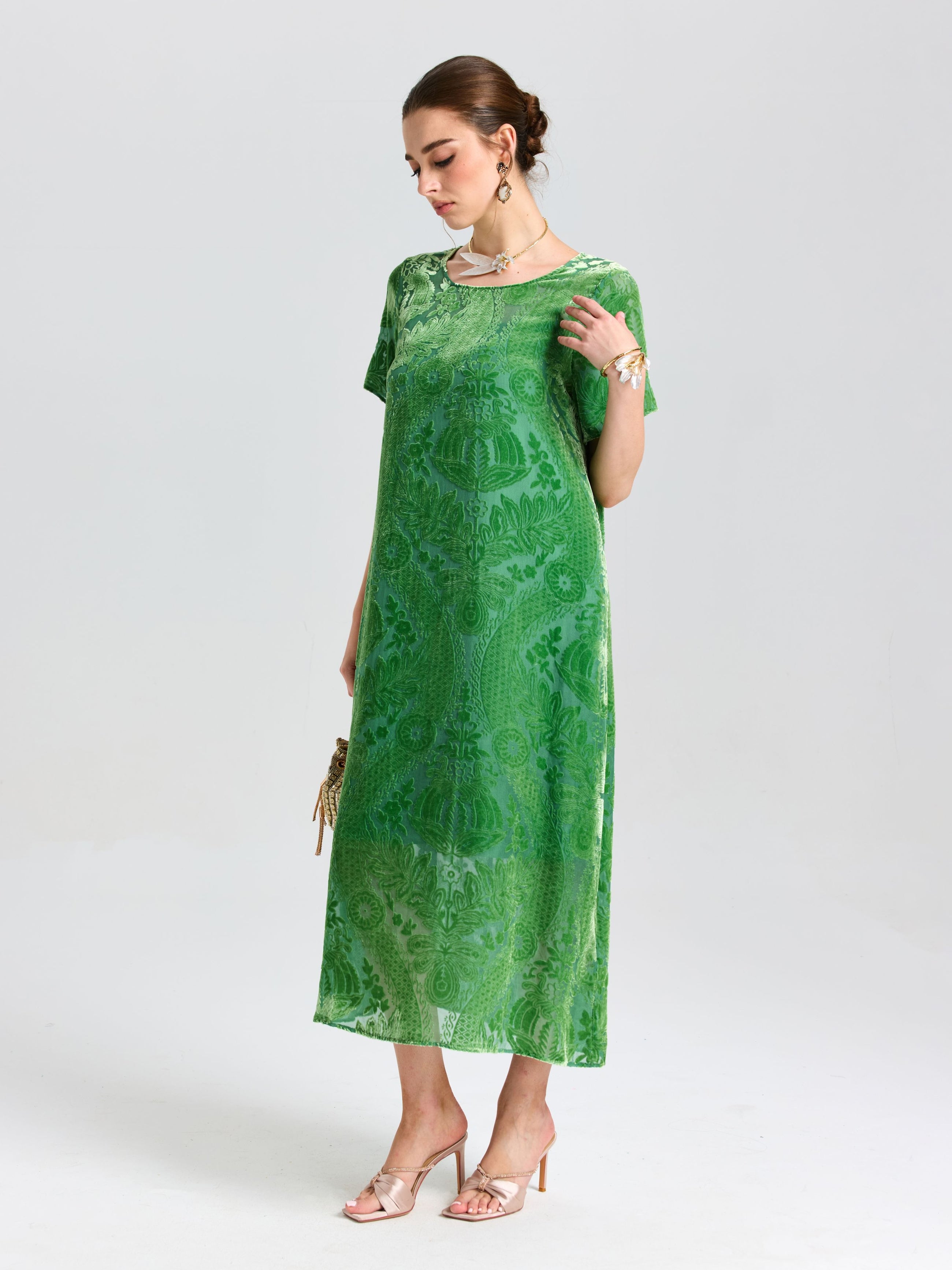 A woman wears the Social Queen Floral Silk Velvet Shift Dress (Cami Included), paired with nude heels and jewelry, holding a small clutch against a plain light background.