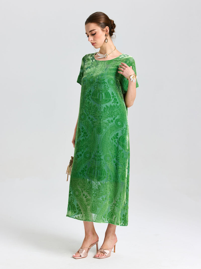 A woman wears the Social Queen Floral Silk Velvet Shift Dress (Cami Included), paired with nude heels and jewelry, holding a small clutch against a plain light background.
