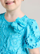 A child smiles against a plain backdrop wearing the Social Queen Girls 3D Floral Appliqué Cutwork Lace Dress.