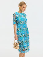 A woman in the Social Queen Floral Appliqué Lace Shift Dress holds a small gold handbag and looks downward against a plain white background.