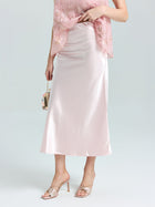 A person in the Social Queen Satin A-Line Midi Skirt, paired with a lace top, heeled sandals, and a small handbag, stands against a plain background.