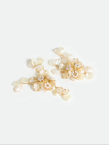 The Social Queen Floral Pearl Drop Earrings feature a gold-tone floral design with ivory petal-shaped accents and delicate pearl details, shown against a plain white background.