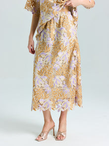 A model wears the Social Queen Floral Embroidered Lace Midi Skirt with a matching top and light open-toe heels, posed against a plain background.