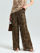 Wearing Social Queen Sequin Fringe Wide-Leg Pants and a beige patterned sleeveless top, this look—finished with a brown perforated handbag—is ideal for statement lovers headed to evening events.