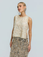 A woman wearing the Social Queen Floral Beaded Mesh Sleeveless Top paired with a silver fringe skirt, standing against a plain light background.