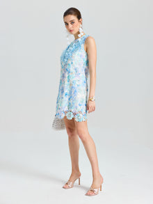 A woman wears the Social Queen Embellished Floral Lace Mini Dress and heeled sandals, posing against a plain white background while looking at the camera.