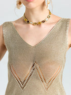 A woman wears the Social Queen Open-Knit Metallic Sleeveless Top with zigzag cutouts and a gemstone choker; her face is partially visible.