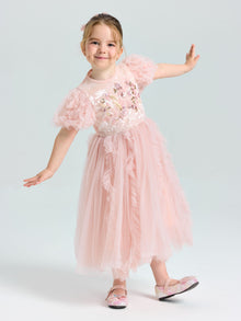 A young girl smiles with arms outstretched, wearing the Social Queen Girls Sequin Embellished Tulle Dress and matching shoes.