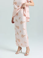 A person wearing the Social Queen Dragonfly Beaded Lace Midi Skirt in light pink with a matching top and heeled sandals stands against a plain background.
