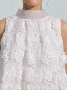 A person wearing the Social Queen 3D Floral Lace Appliqué Silk Top, featuring a sleeveless white design with sheer fabric, textured lace detailing, and delicate 3D floral embellishments.