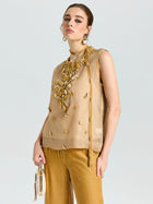 A woman wears the Social Queen Velvet Scarf Silk Organza Top (cami included), styled with gold wide-leg pants, statement jewelry, and a beige handbag against a plain background.