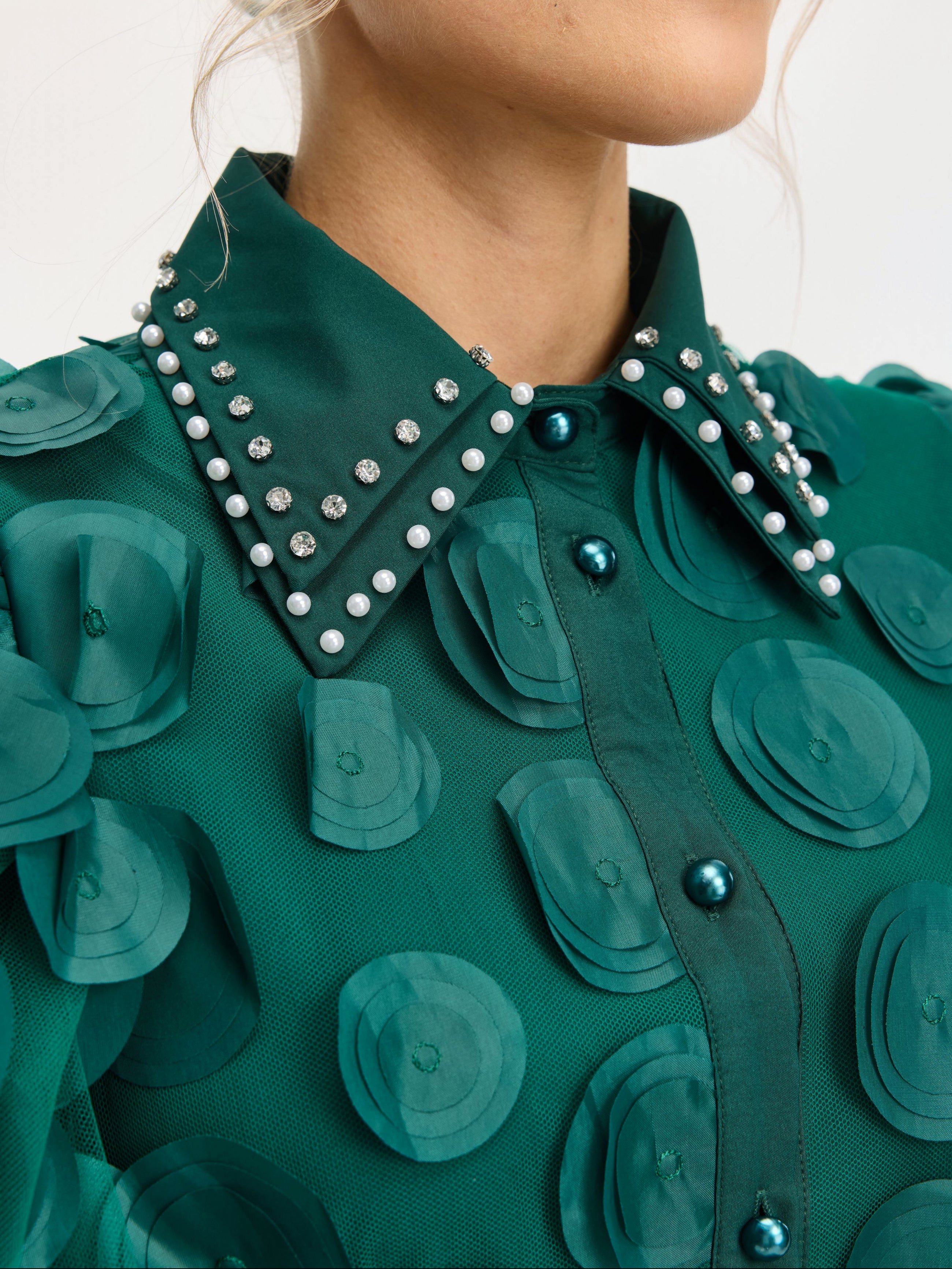Close-up of the Social Queen Pearl Embellished Appliqué Dress, showcasing layered circular appliqués and a pointed collar adorned with crystal pearls and rhinestones.