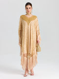 A woman faces forward in the Social Queen Beaded Fringe Cape Dress, styled with matching earrings and a small beaded handbag. She wears light makeup and has her hair pulled back.