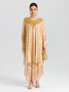 A woman faces forward in the Social Queen Beaded Fringe Cape Dress, styled with matching earrings and a small beaded handbag. She wears light makeup and has her hair pulled back.
