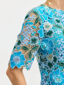Close-up of a person wearing the Social Queen Floral Appliqué Lace Shift Dress with sheer sleeves and embroidered floral lace.