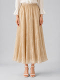 A person wearing the Social Queen Jacquard Chiffon Midi Skirt in beige with a subtle floral pattern, styled with a crisp white blouse and white heeled sandals, stands against a plain background.