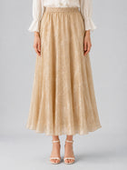 A person wearing the Social Queen Jacquard Chiffon Midi Skirt in beige with a subtle floral pattern, styled with a crisp white blouse and white heeled sandals, stands against a plain background.