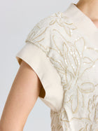Close-up of a person wearing the Social Queen Floral Embroidered Linen Top, featuring textured floral embroidery, sequin accents, and relaxed batwing sleeves.