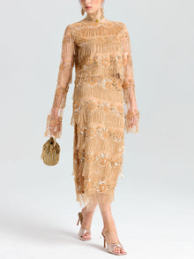 A person wearing the Social Queen Beaded Fringe Floral Top, styled with a gold beaded bag and open-toe heeled sandals.