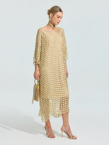 A woman wears the Social Queen Pearl Embellished Floral Overlay Dress (Slip Dress Included) with gold high-heeled sandals and a small gold handbag, standing against a plain background.