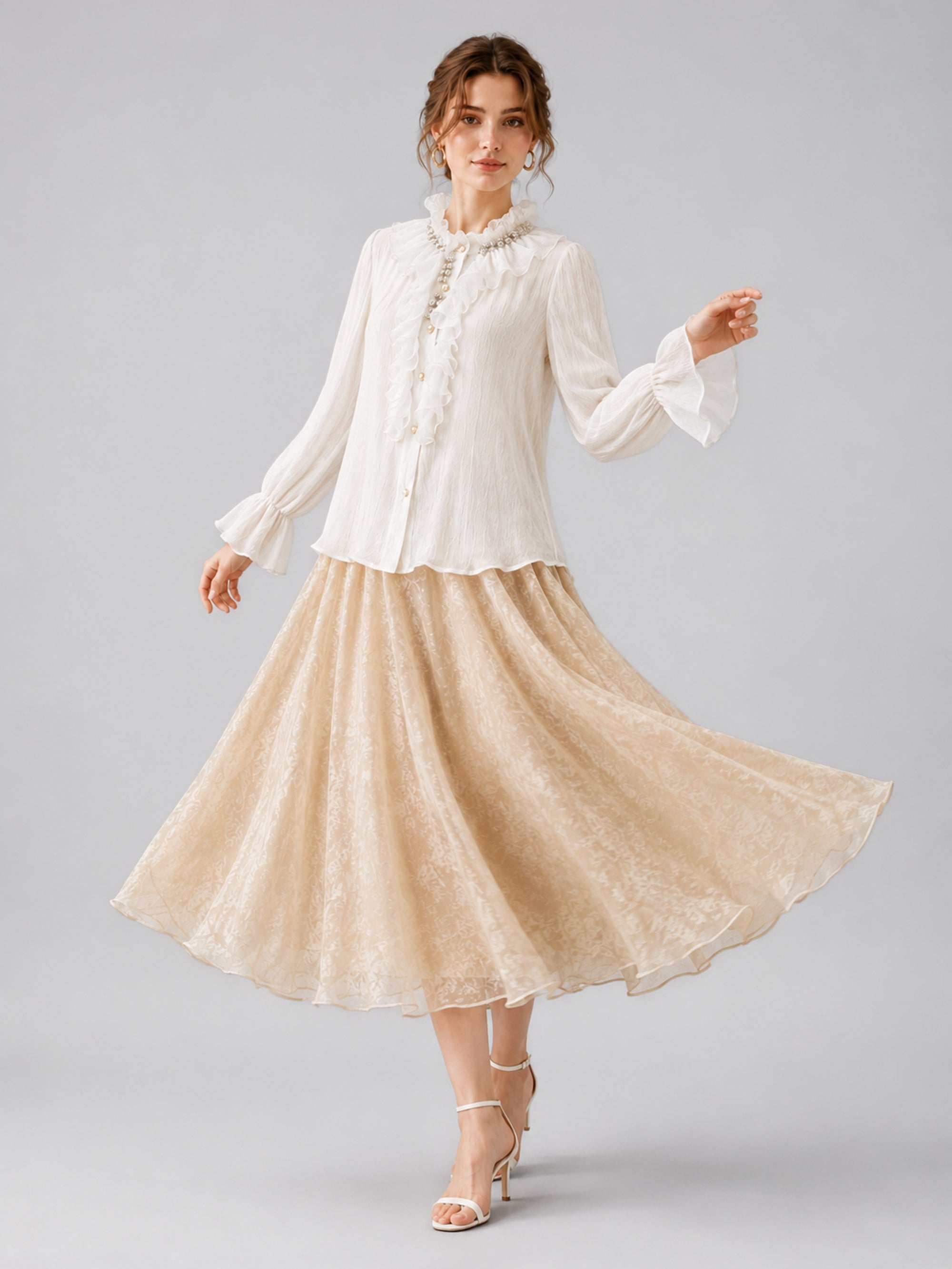 A woman stands in a studio wearing a white ruffled blouse, chic white heels, and the Social Queen Jacquard Chiffon Midi Skirt—its elegant silhouette flowing gracefully as she twirls her skirt.