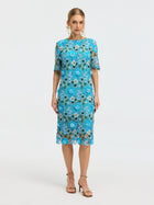 A woman wears the Social Queen Floral Appliqué Lace Shift Dress with short sleeves and gold sandals, standing against a plain light background.