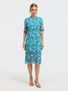 A woman wears the Social Queen Floral Appliqué Lace Shift Dress with short sleeves and gold sandals, standing against a plain light background.