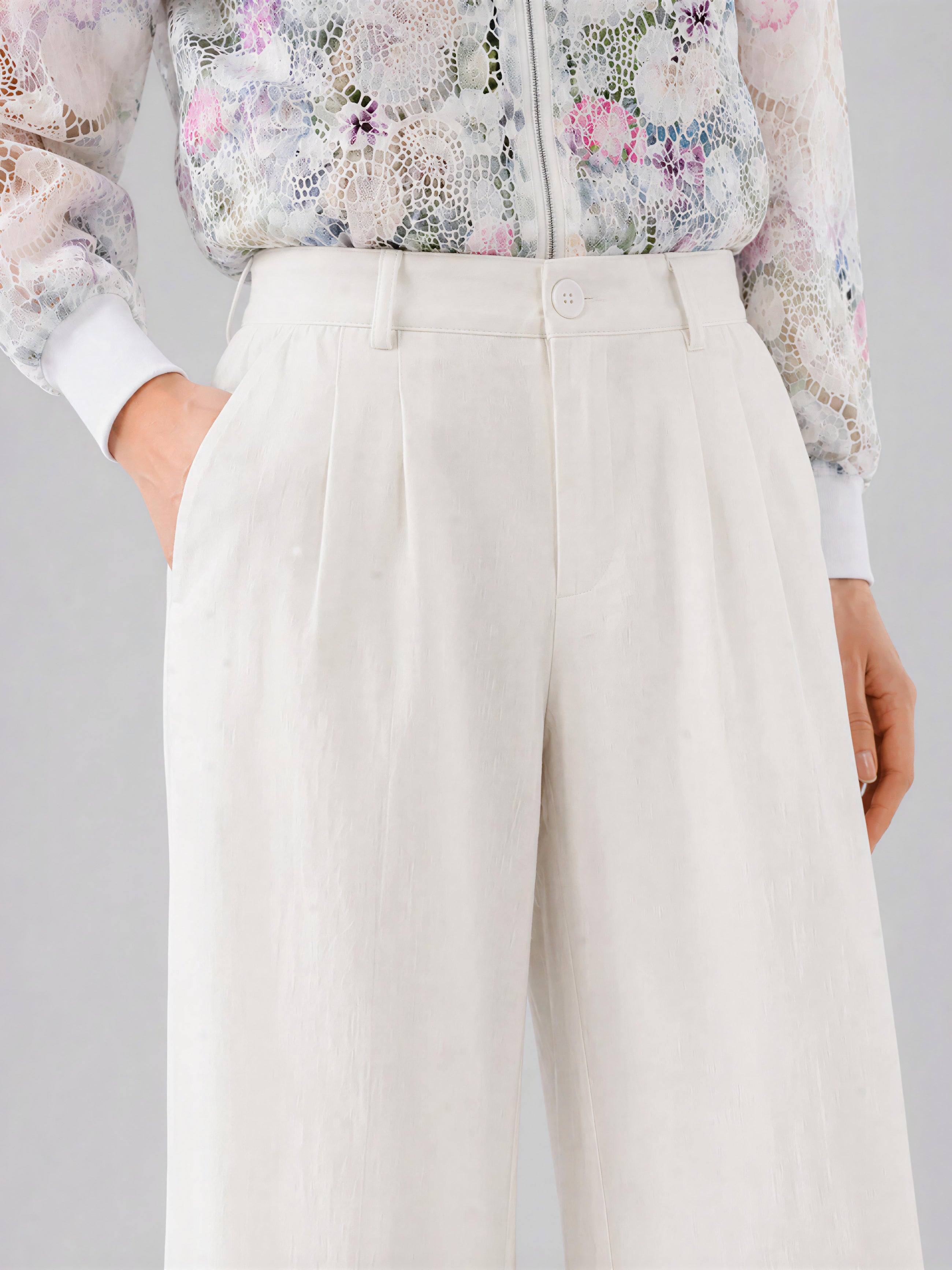 Model wearing Social Queen’s Casual Wide-Leg Pants, featuring a high-waisted silhouette in lyocell-linen with a textured finish, paired with a floral lace blouse and hands in pockets; shown from the waist down.