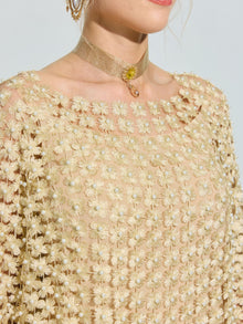 A person wears the Social Queen Pearl Embellished Floral Overlay Dress with 3D floral appliqués and pearl accents, styled with a gold choker necklace featuring a small yellow gemstone.