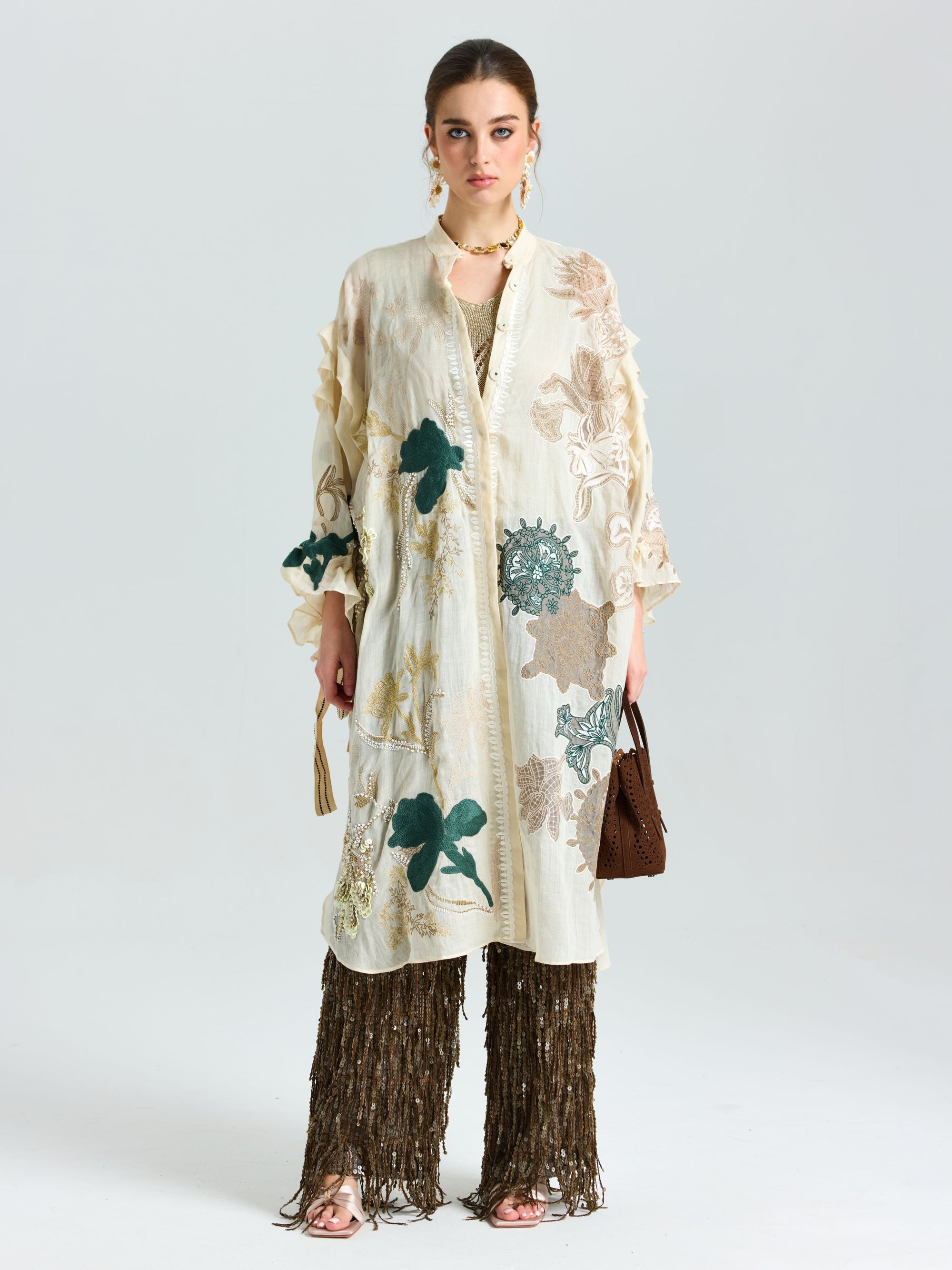 A woman models the Social Queen Floral Embroidered Linen Jacket (Cami Included) over brown textured pants, holding a brown handbag against a plain background.