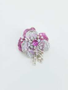 The Social Queen Gradient Peony Rhinestone Brooch, shaped like a flower and adorned with pink and white gemstones along with pearl accents, is displayed against a plain white background.