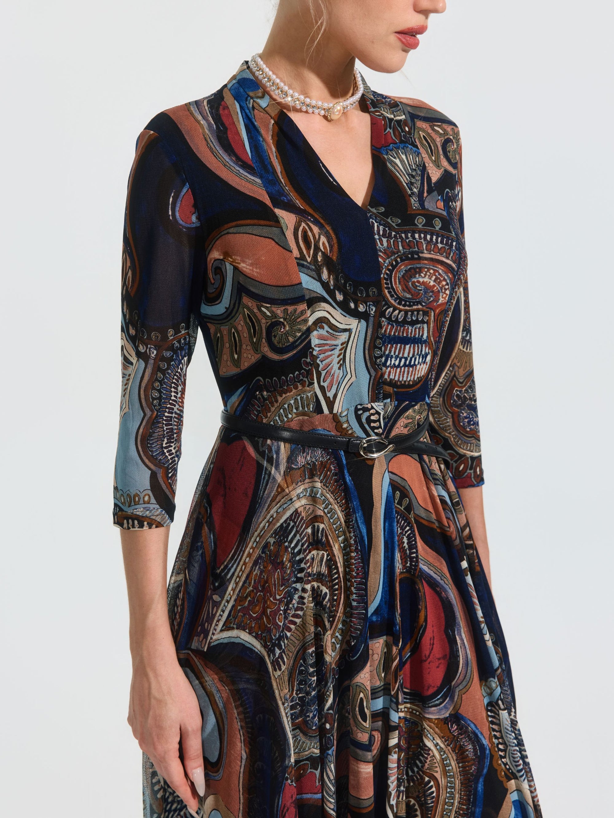 A woman models the Social Queen Paisley Print Knit Dress (Belt Included), featuring three-quarter sleeves, shown from shoulders to knees against a plain background.
