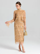 A woman wears the Social Queen Beaded Fringe Floral Top, paired with a small gold handbag and open-toe heels, standing against a plain background.
