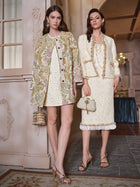 Two women in Social Queen’s Italian Baroque Floral Metallic Jacquard Jackets and heeled sandals pose indoors amid vintage baroque floral decor, radiating sophisticated charm under soft lighting.