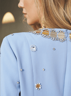 Close-up of a woman in the Social Queen Jewel-Beaded Gold-Trim Dress, featuring shimmering hand-beaded jewels and elegant gold accents, her blonde hair gracefully draped over her shoulder.