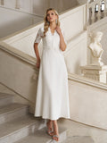 A woman in the Social Queen Lace-Panel Satin A-Line Gown stands on a staircase beside a classical statue in an elegant, light-toned interior.