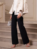 A person wearing Social Queen's Lace-Trim Straight-Leg Trousers, a white blouse, a cream embellished blazer, heeled sandals, and carrying a silver handbag stands on a staircase.